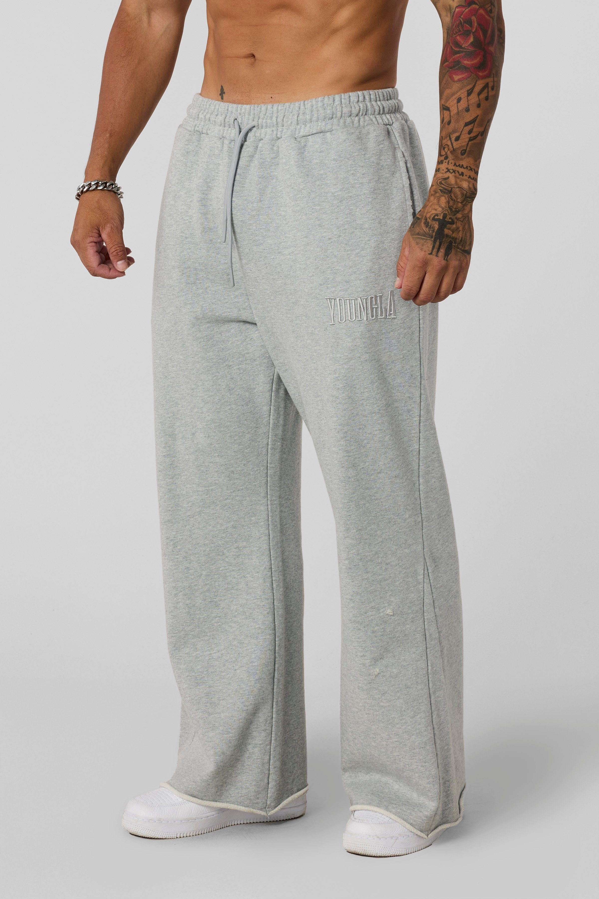 2077 - Flare Sweats - Heavyweight fleece sweats with structure and warmth. Minimal branding and clean lines create a bold, everyday-ready silhouette in Heather Grey.