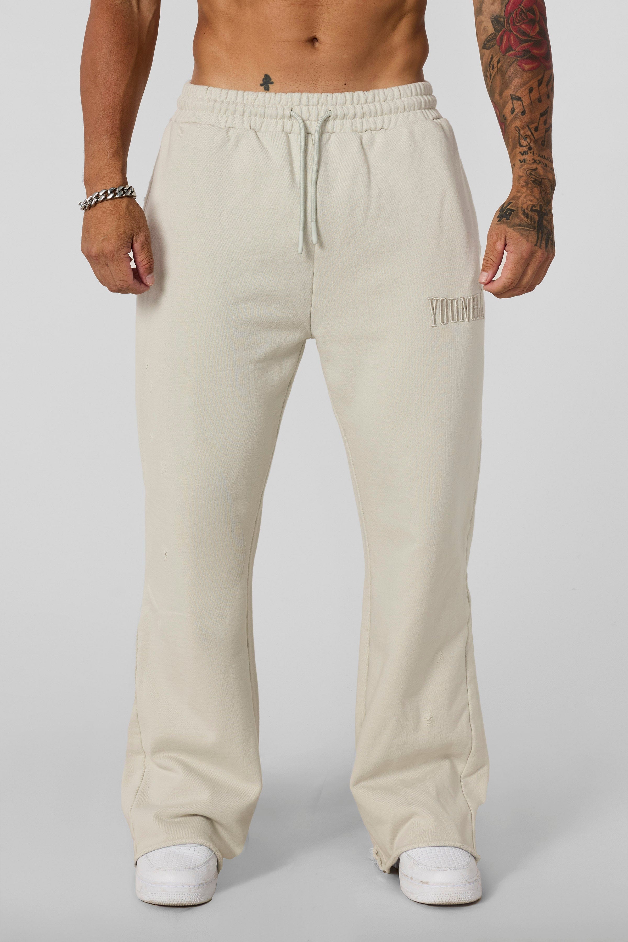 2077 - Flare Sweats - Heavyweight fleece sweats with structure and warmth. Minimal branding and clean lines create a bold, everyday-ready silhouette in Bone Wash.