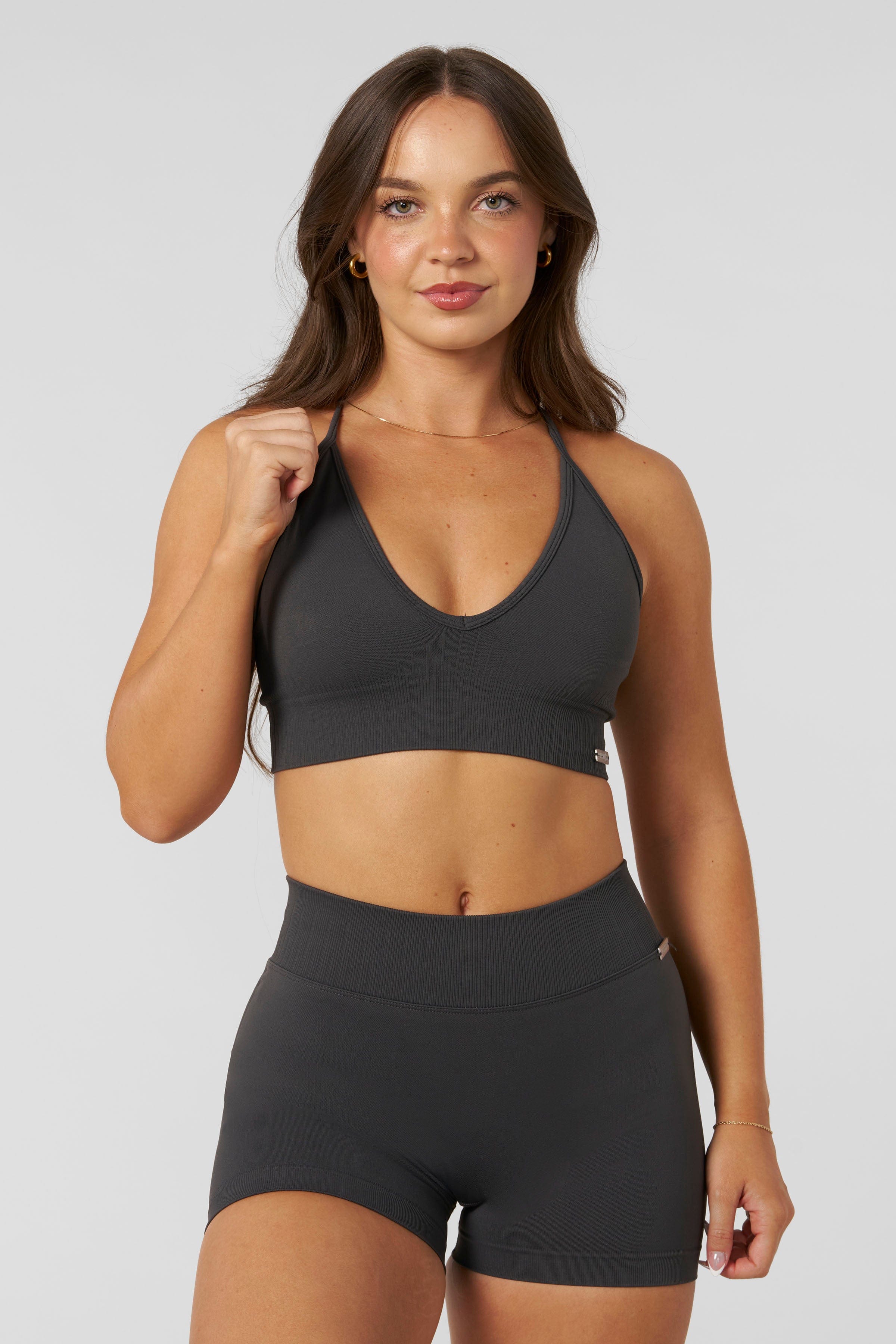W367 - Sculpt Seamless Plunge Bra - Medium Impact Bra — ultra-soft seamless design with a flattering deep V-neckline and removable padding for adjustable support in colour Charcoal.