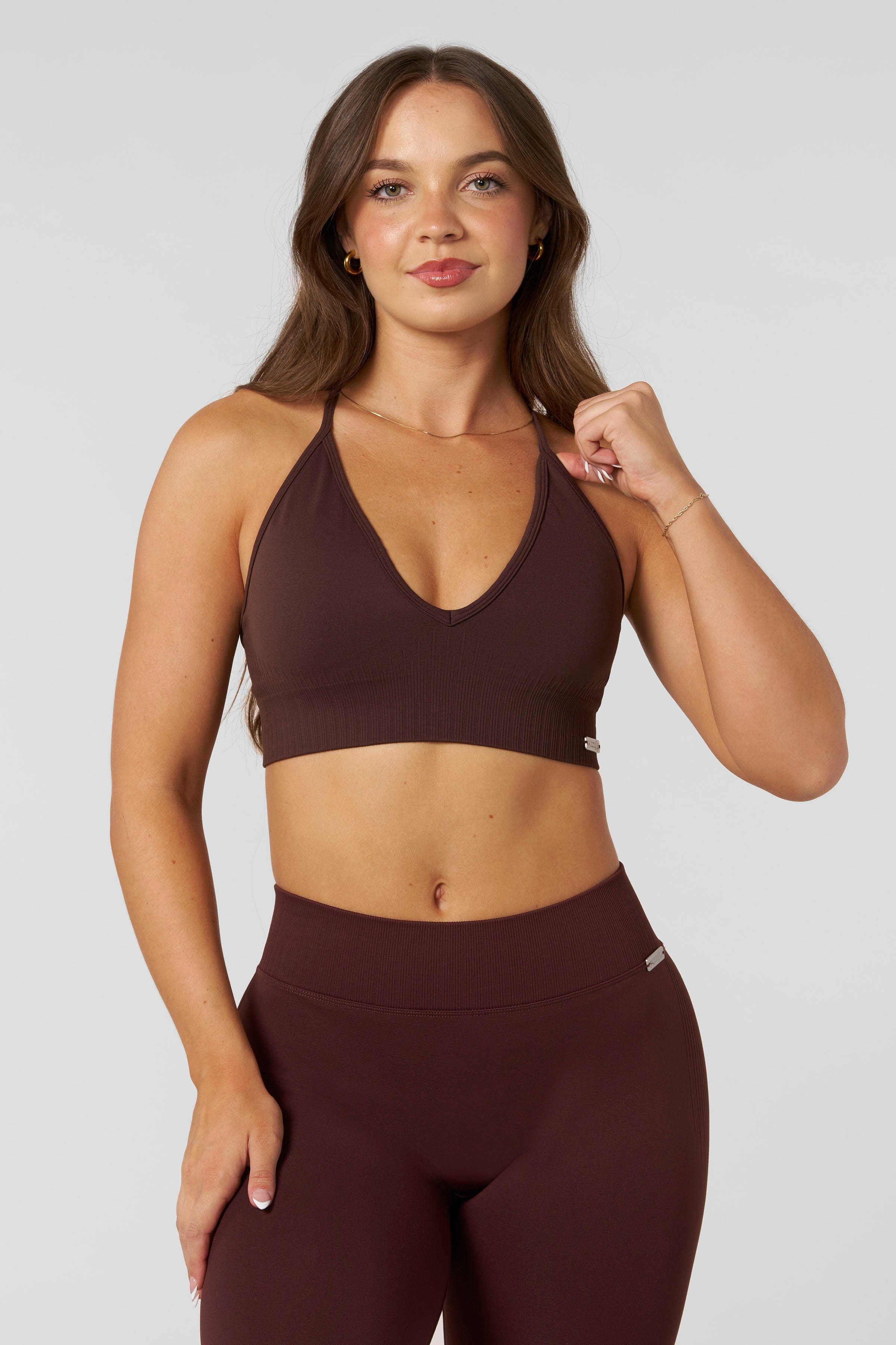 W367 - Sculpt Seamless Plunge Bra - Medium Impact Bra — ultra-soft seamless design with a flattering deep V-neckline and removable padding for adjustable support in colour Burgundy.