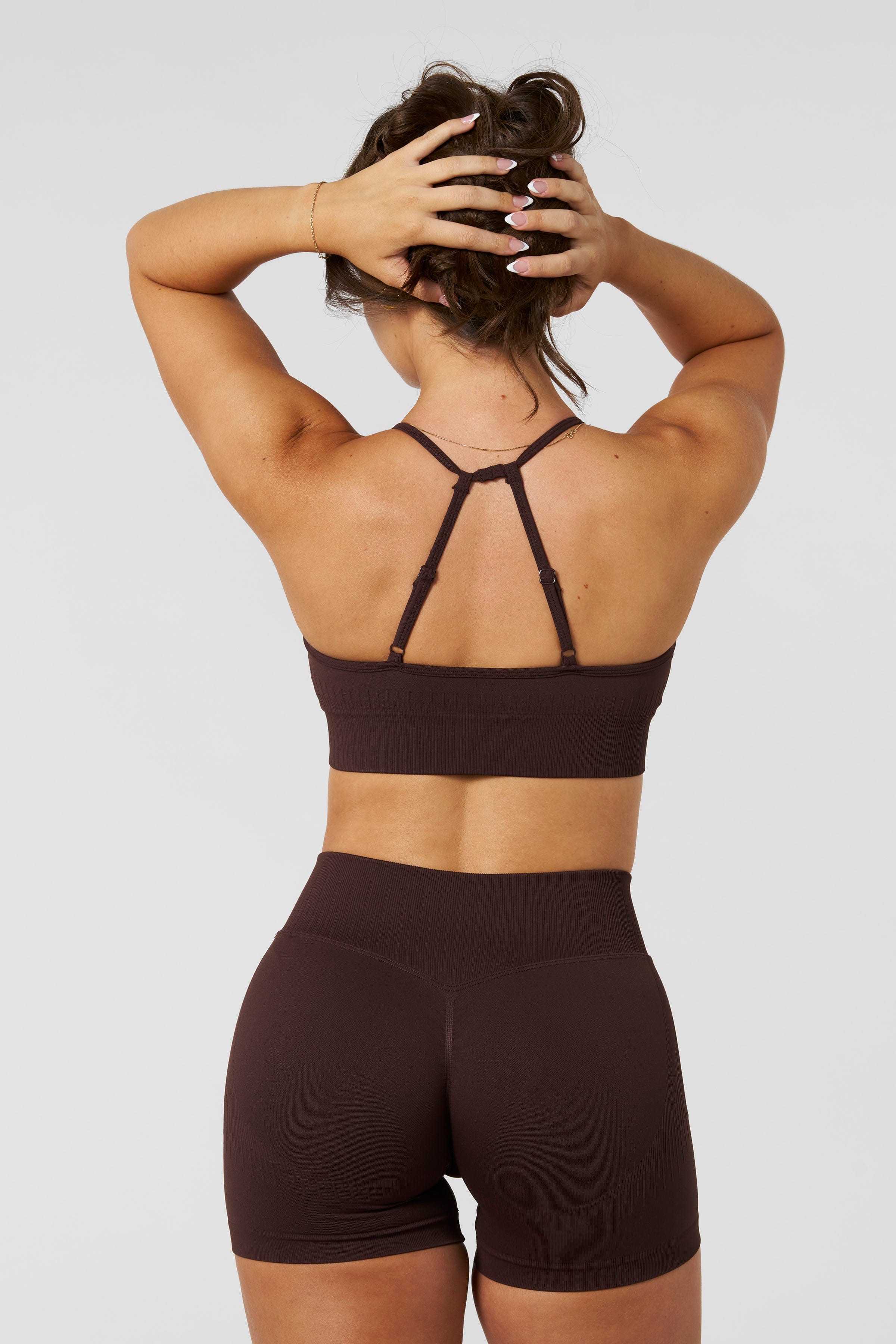 W367 - Sculpt Seamless Plunge Bra - Medium Impact Bra — ultra-soft seamless design with a flattering deep V-neckline and removable padding for adjustable support in colour Brown.